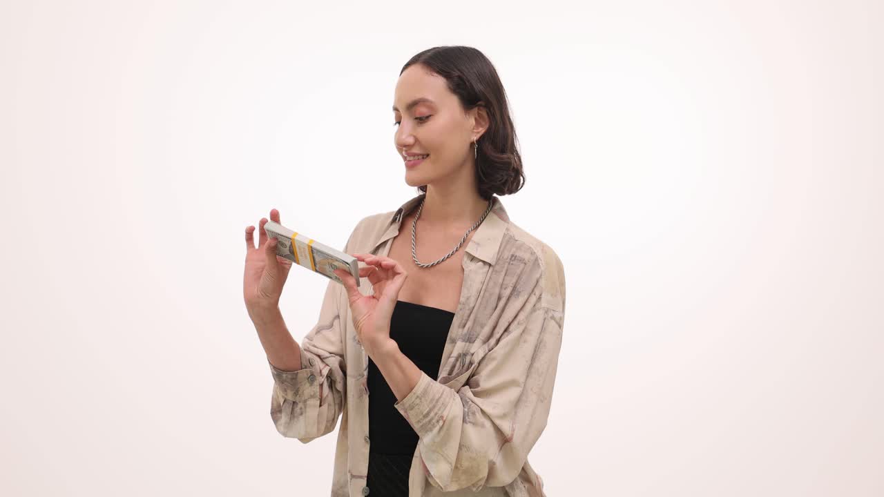 Woman holding stack of money