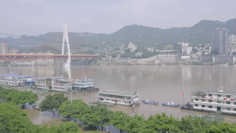 flood rises under a bridge in chongqing