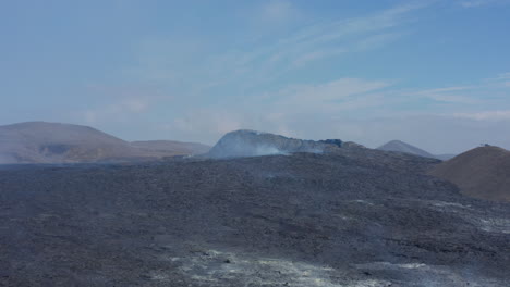 Iceland-Fagradalsfjall-volcano,-black-lava-landscape.-Aerial-drone-flying-forward-above-Reykjanes-Peninsula-hotspot,-day