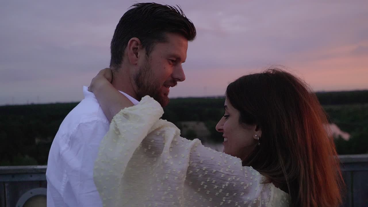 Dancing couple on top of the sahara tower at sunset in Lommel, Belgium