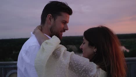 dancing couple on top of the sahara tower at sunset in lommel, belgium