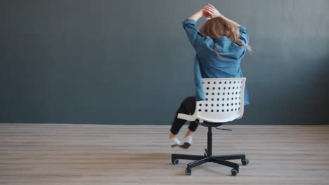 woman dancing in a chair with headphones