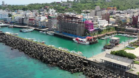 aerial drone hovering around baishawei fishing harbor town at xiaoliuqiu lambai island, pingtung, taiwan