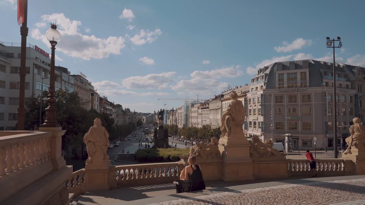Sunny wide angle shot, panning pov looking out from Prague National Museum, in real time, Czech Republic