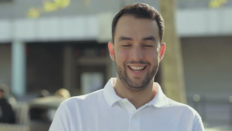 happy handsome bearded young man looking at camera.