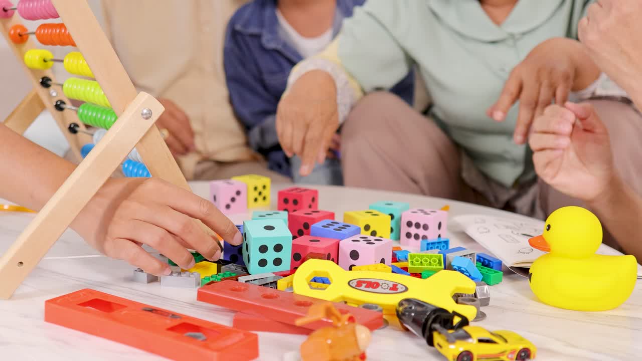 Three generations play with colorful educational toys, laughing and bonding in a bright living room