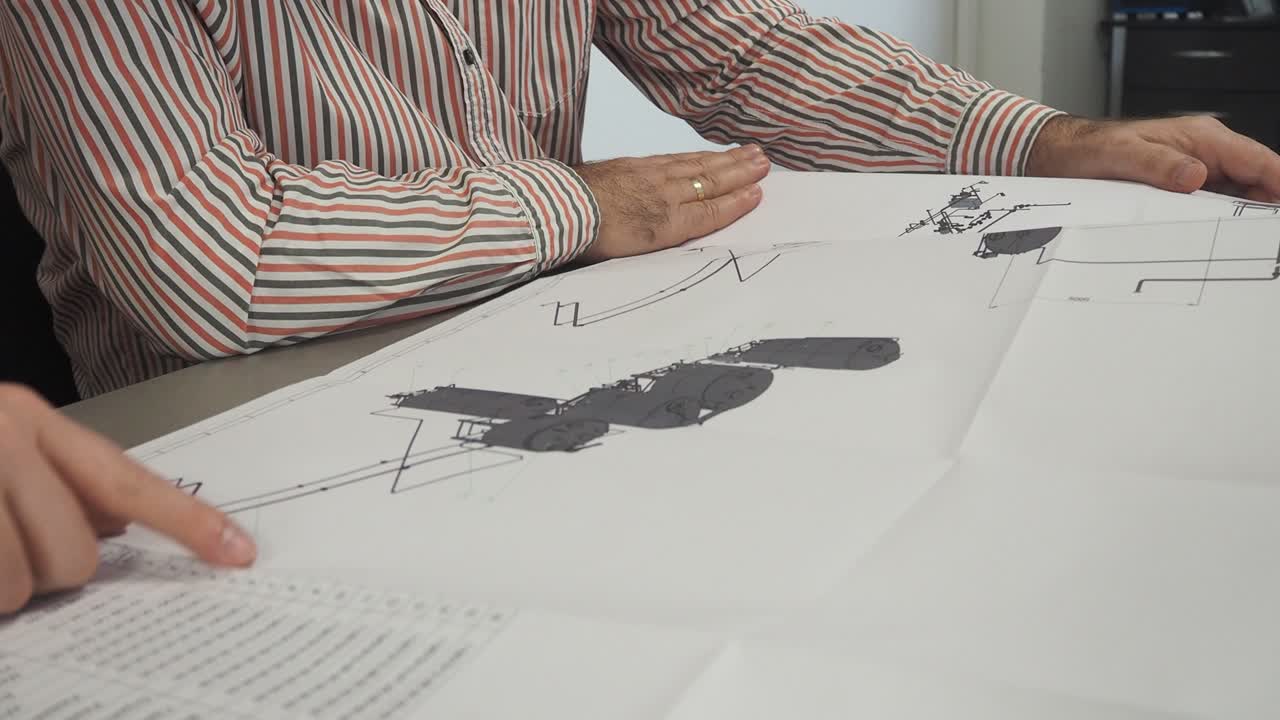 기계 엔지니어, 설계자는 청사진에 대한 문제를 토론합니다.