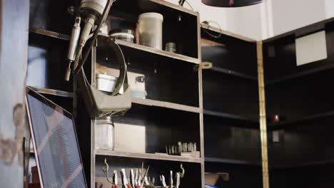 close up of laptop and handcraft tools in studio in slow motion