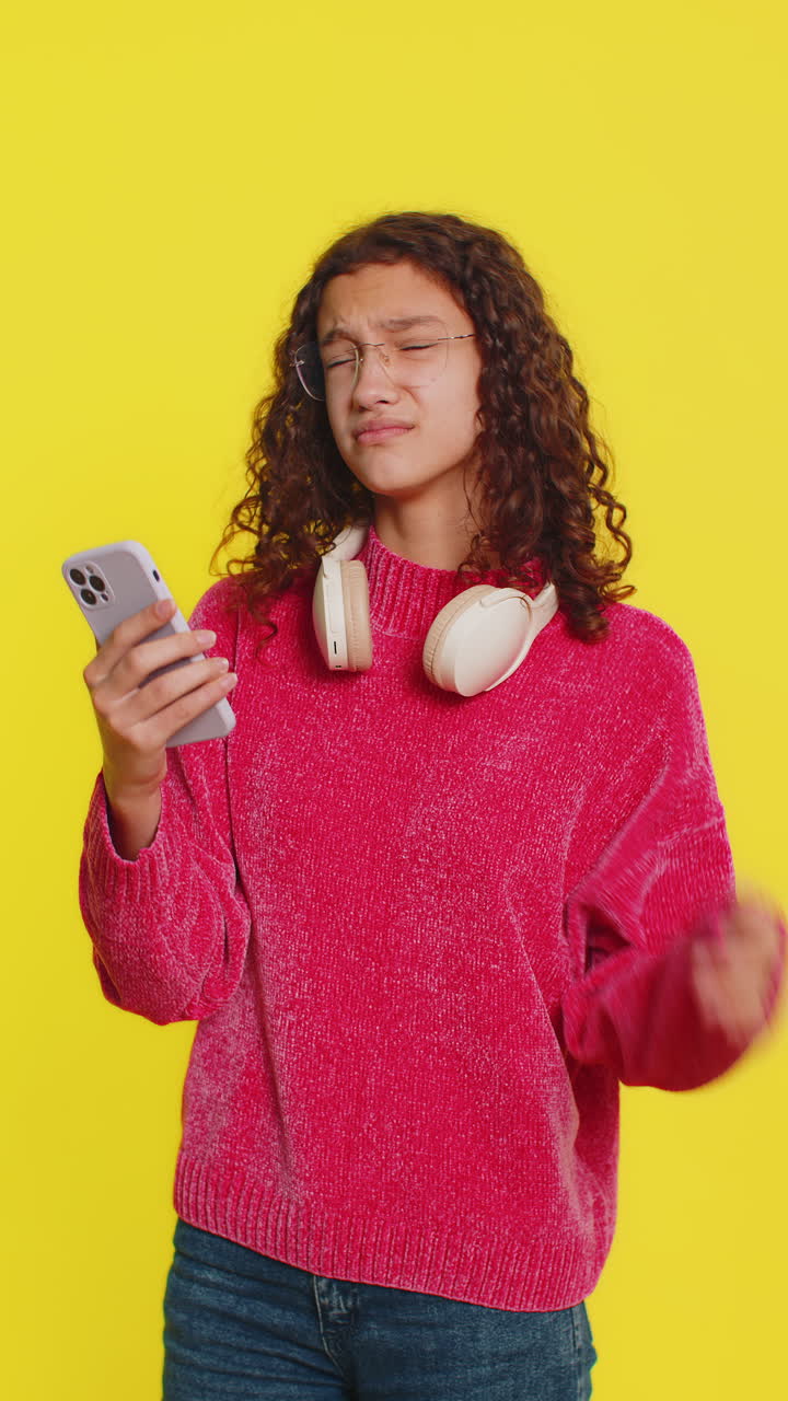 Upset sad girl use smartphone play game loses loss fail unlucky news bad lottery results crisis