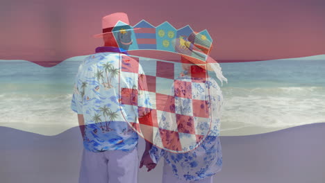 pareja de manos en la playa con animación de la bandera de croacia sobre la escena