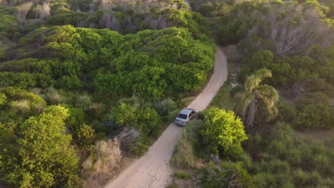 car driving on unpaved road at punta del diablo in uruguay