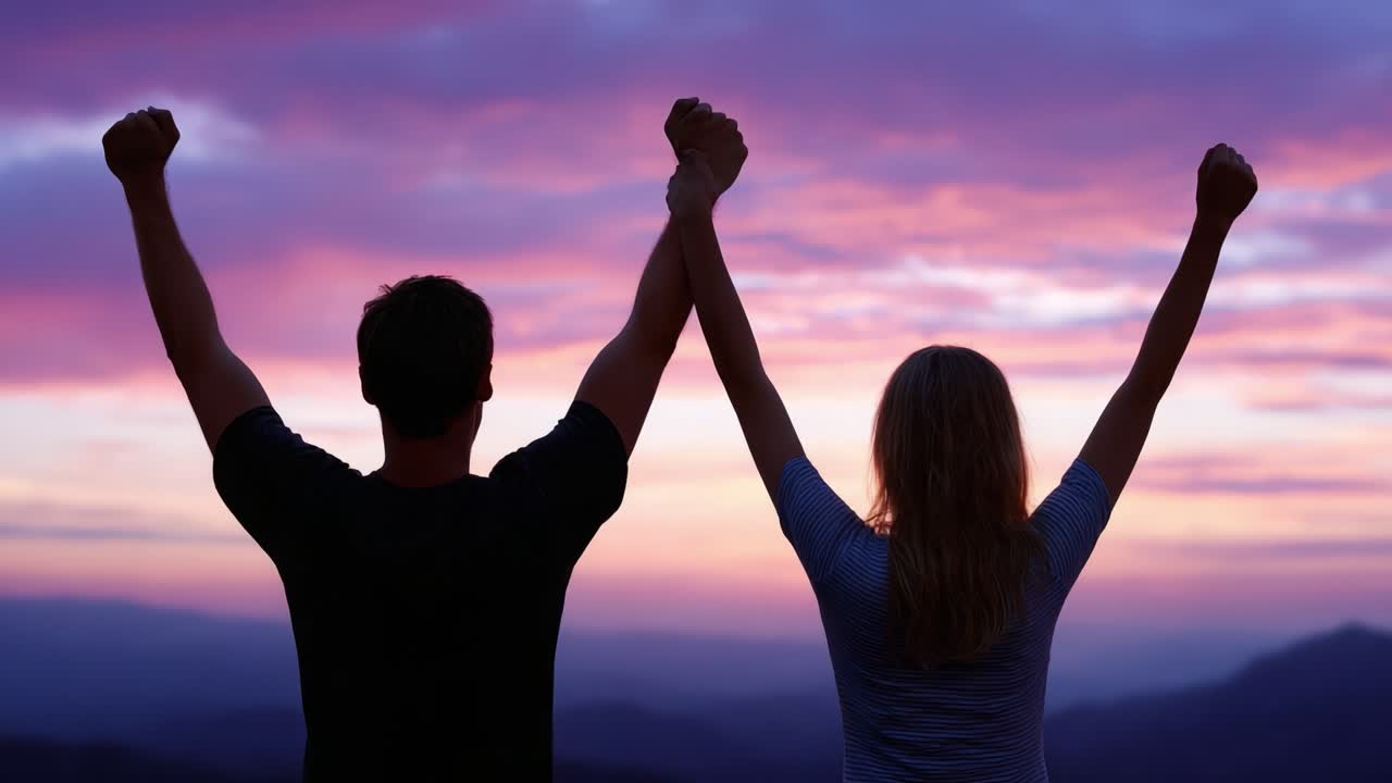 A Celebratory Moment: Two Individuals Raise Their Hands in Triumph Against a Beautiful Sunset Sky, Signifying Success, Joy, and Connection in Nature's Splendor