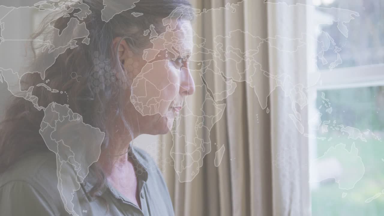 Camera panning over mature woman gazing garden through window while world map overlay persisting