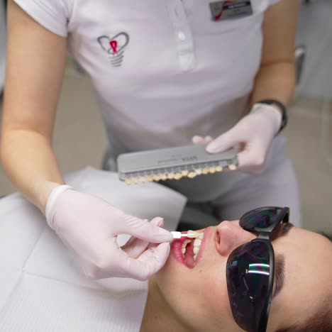 woman patient having dental treatment. beautiful young woman doing tooth examination in the dental office