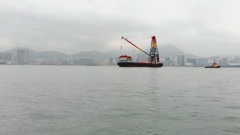 industrial harbor scene with a foggy skyline and a mountainous island