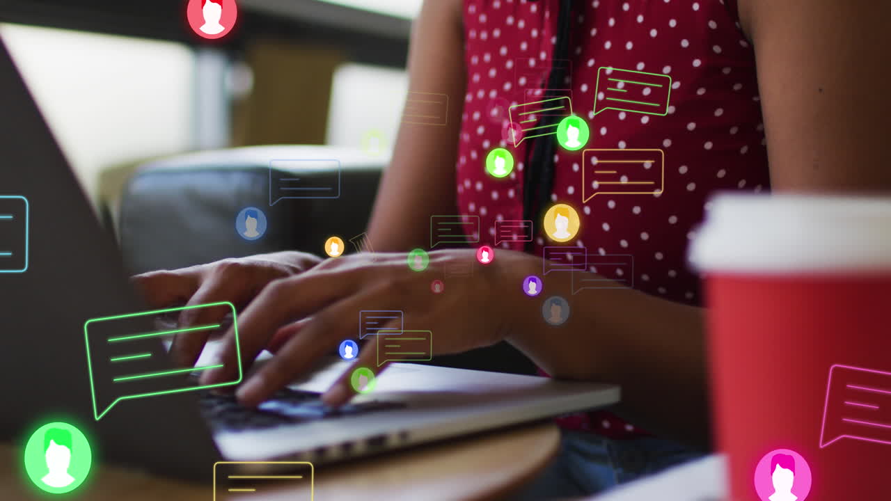 Animation of media icons over african american businesswoman using laptop