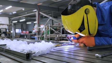 man wearing mask welding in a workshop. metal workers use manual labor. skilled welder. welder is welding the stainless steel pipes in the factory. welder industrial part in factory.