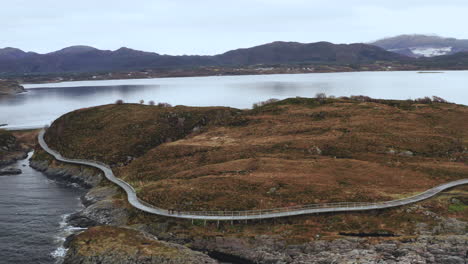 Tourist-At-The-Atlantic-Road-Walking-Pathway-On-Rugged-Coastline-In-Norway