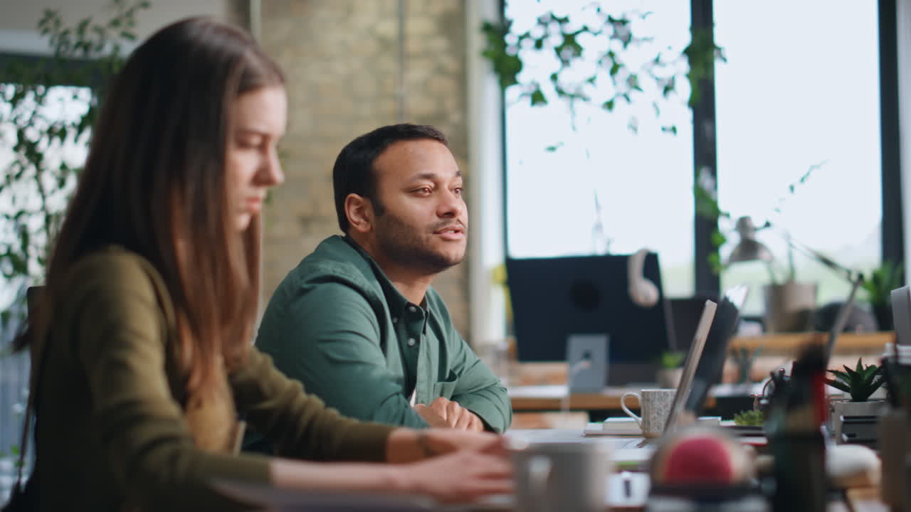 Office coworkers brainstorming sitting conference room with laptops close up.