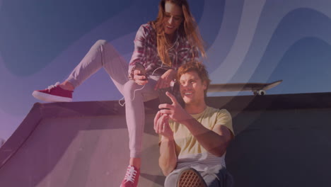 man and woman sharing smartphone finance data on skatepark ramp, showing animated charts