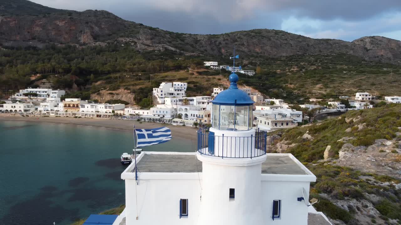 Aerial View of a Picturesque Greek Island Lighthouse and Coastal Town