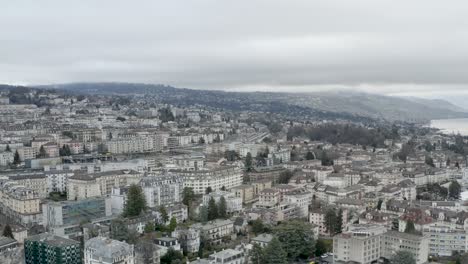 Drone-Aerial-of-the-beautiful-swiss-city-center-of-lausanne-located-on-the-lake-geneva-in-Switzerland-during-winter,-Europe