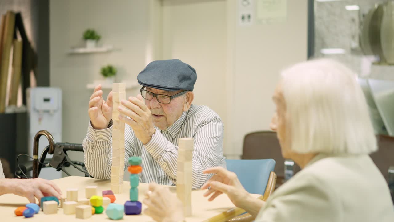 Elderly residents playing with wooden blocks