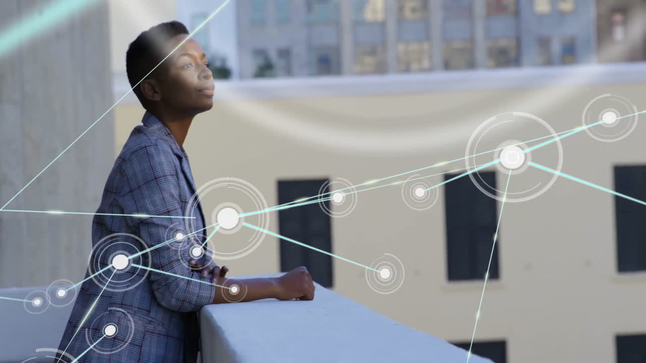Animation of network of connections over african american businesswoman standing on balcony