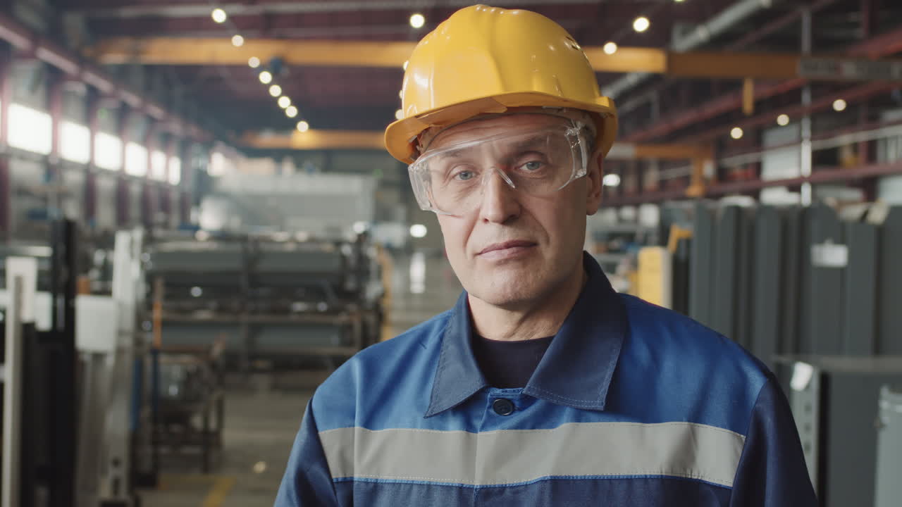 Portrait Of Senior Plant Supervisor With Walkie-Talkie