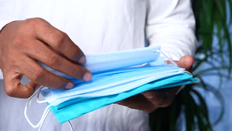 person holding a stack of face masks