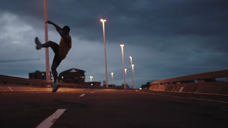 dancing man young break dancer performing modern hip hop dance moves practicing urban freestyle choreography in city street at night