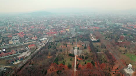 Budapest,-Hungary,-Flying-over-Kerepesi-Cemetery-by-Drone-in-autumn,-golden-and-brown-leaves,-hazy,-foggy-weather,-Ferenc-Deák-Mausoleum---tomb