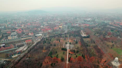 budapest, hungary, flying over kerepesi cemetery by drone in autumn, golden and brown leaves, hazy, foggy weather, ferenc deák mausoleum - tomb