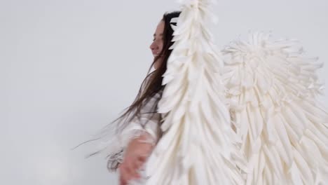 woman in angel wings and white robe