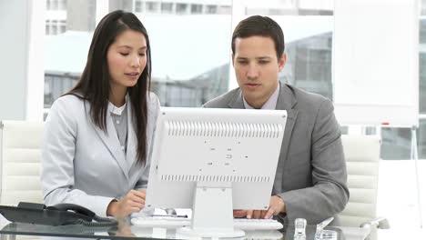 assertive business team working at a computer