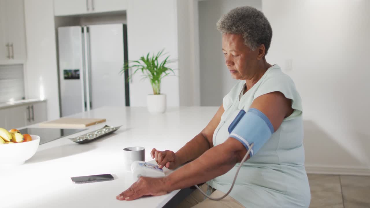 Senior african american woman measuring pressure alone at home