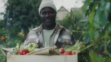 Portrait of Black Man with Harvest in Garden