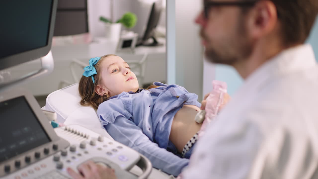 Doctor performing an ultrasound examination on a young girl