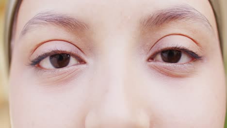 Video-close-up-portrait-of-the-eyes-of-a-happy-biracial-woman-smiling-to-camera