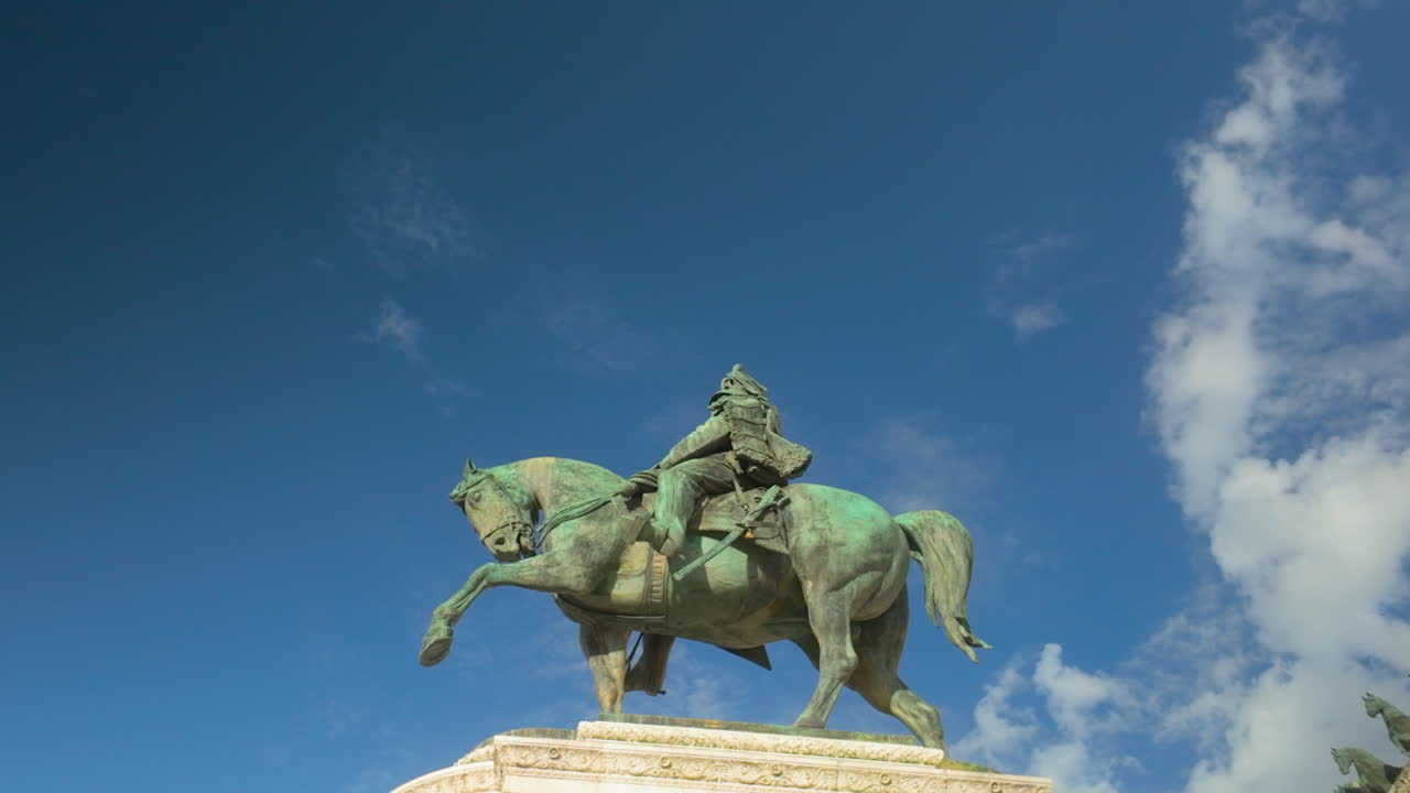 Bronze equestrian statue of a historic figure against a vibrant blue sky in central Rome.