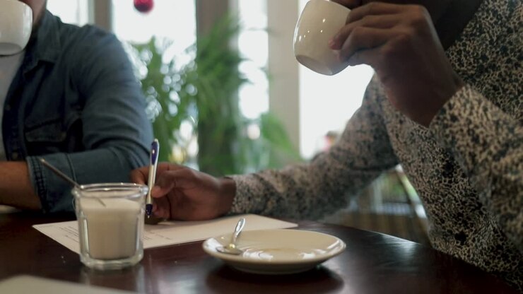 Focused freelancers drinking coffee and working in cafe