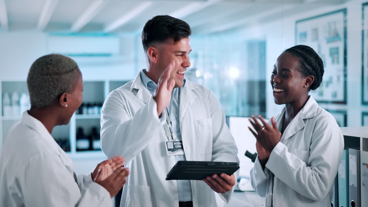 Diverse Team of Scientists Celebrating Success with High Fives in Lab