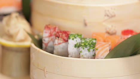 colorful variety of delicious kabuki sushi in traditional wooden bowls -close up