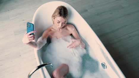 woman-lying-in-bathtub-full-of-foam