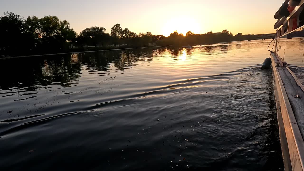 Shot of sunset in the background on water from a luxury yacht sailing during evening time