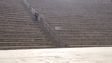 Estudiante-Universitario-Caminando-Solo-En-El-Anfiteatro.