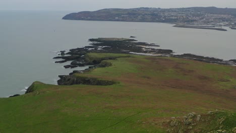 ireland's eye island cliffs revealed as seagulls glide in cinematic aerial