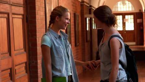 happy students chatting together in a hall