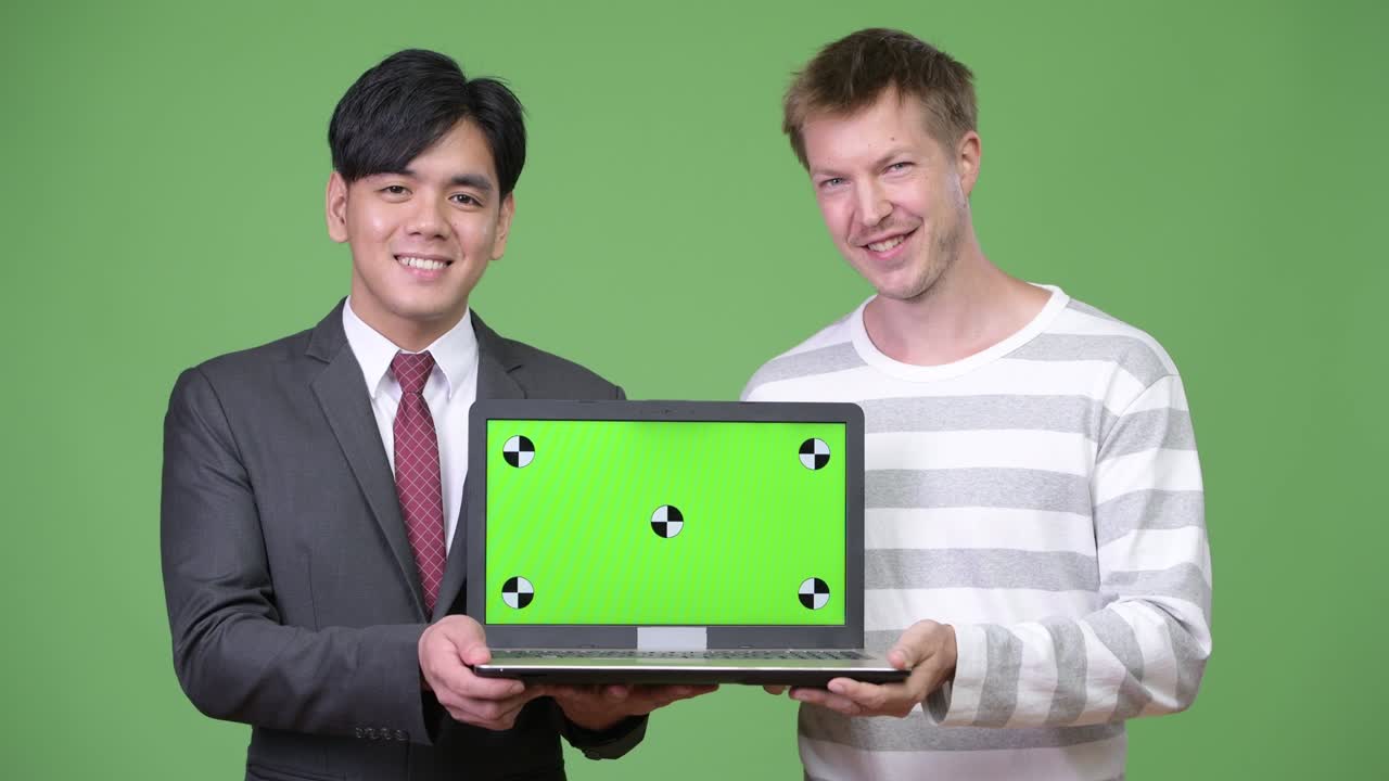 젊은 잘생긴 아시아 사업가와 젊은 스칸디나비아 사업가가 함께 일하고 있습니다.