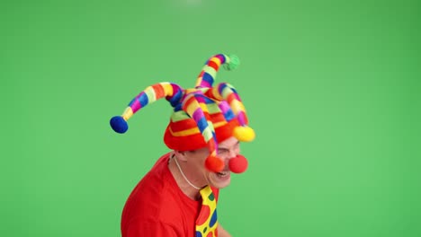 clown with jester hat and red nose laughing